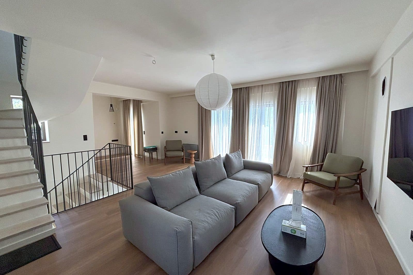 The sitting room, with sofas arranged towards the windows and the view.