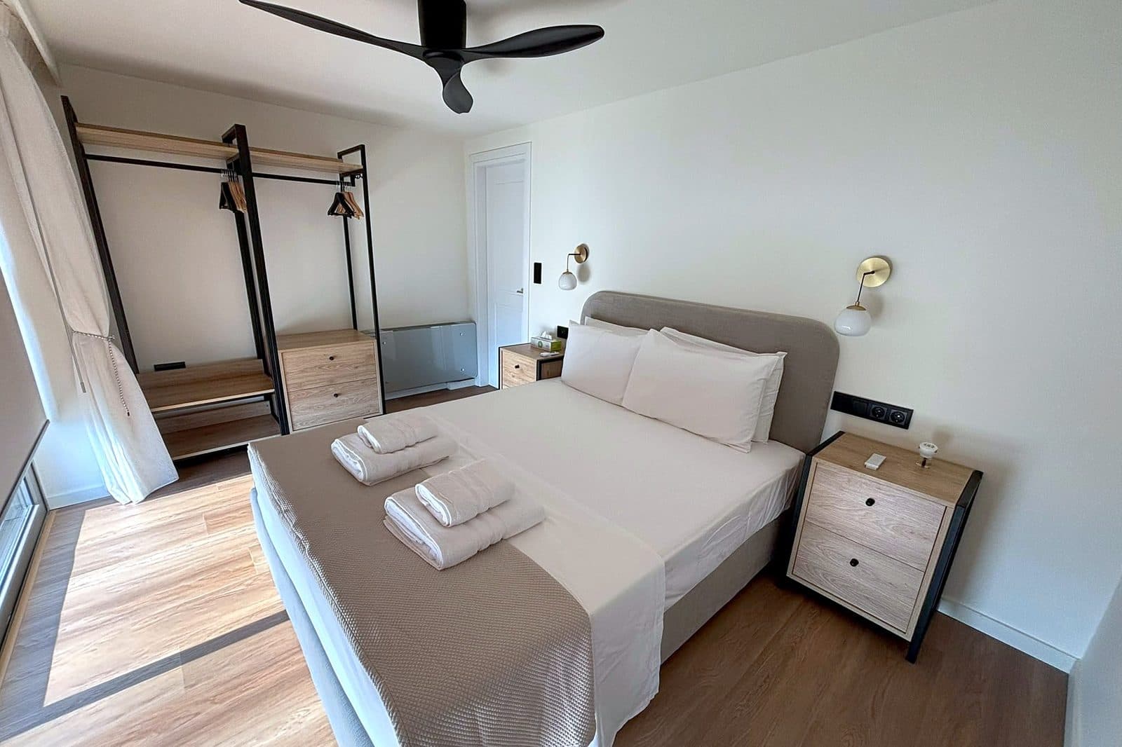 The master bedroom, with a double bed facing windows onto the bay.