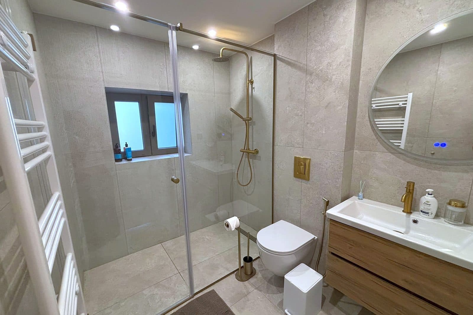 A walk-in shower with a window beside it.